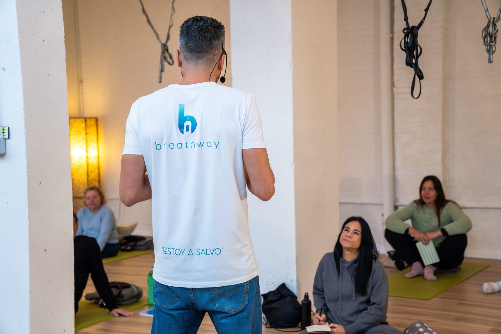 A Breathway facilitator speaking to a seated group